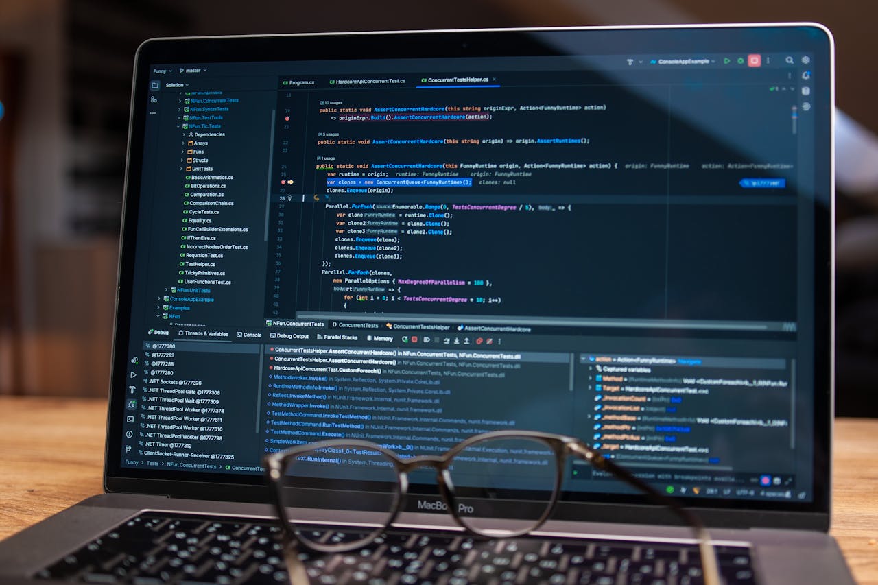 Laptop screen showing debugging software with code, perfect for tech and software development themes.